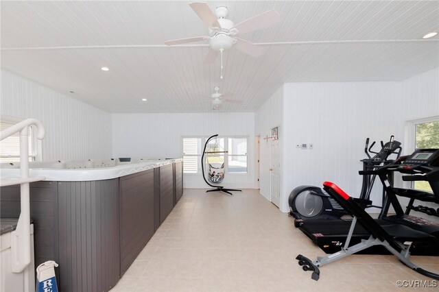 interior space with ceiling fan and dark brown cabinets