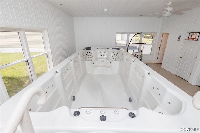 bathroom featuring a wealth of natural light and a bathtub