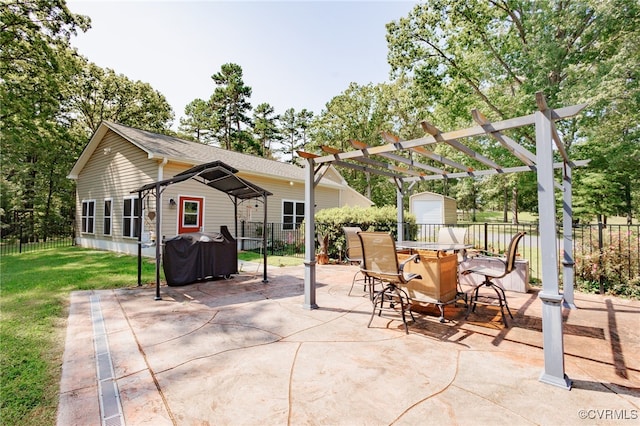 view of patio with a grill and a pergola