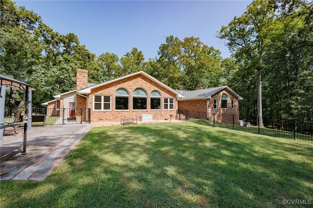 rear view of property with a yard