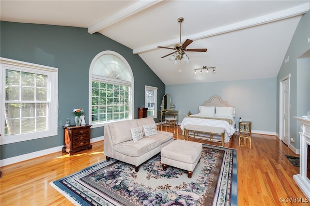 bedroom with ceiling fan, light wood-type flooring, and lofted ceiling with beams