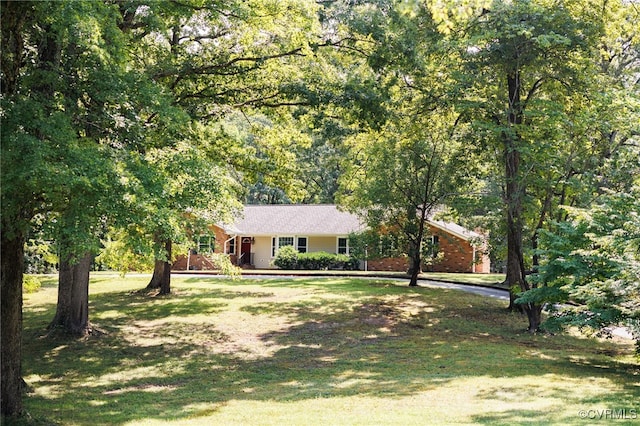 single story home with covered porch and a front yard