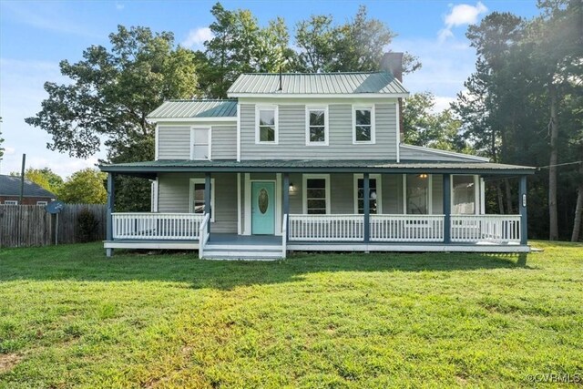 farmhouse-style home featuring covered porch and a front lawn