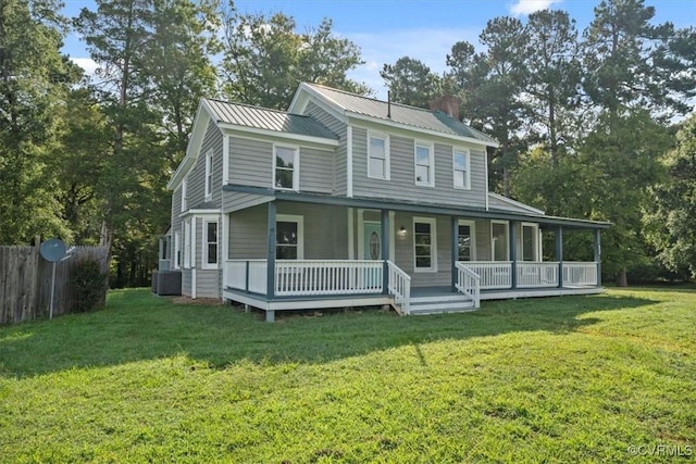 farmhouse inspired home with covered porch and a front yard