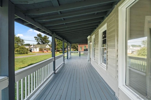 deck featuring a porch and a yard