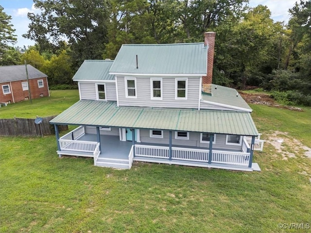 back of house featuring a deck and a lawn