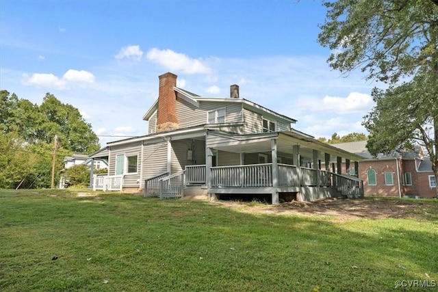 back of house featuring a lawn and a porch