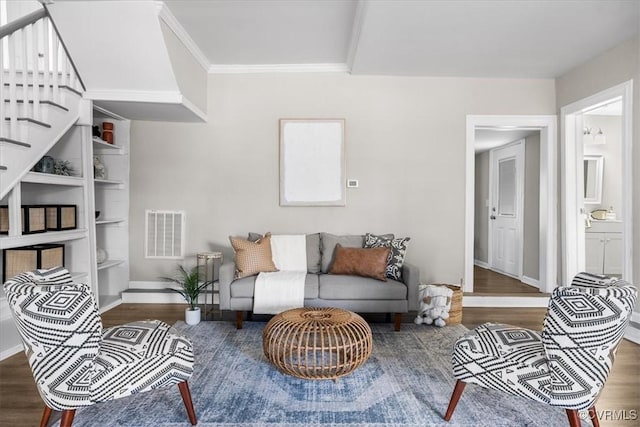 living room featuring dark hardwood / wood-style flooring and crown molding