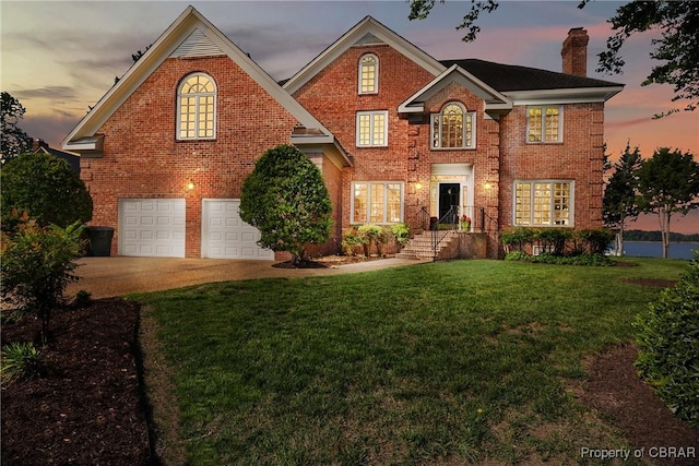 view of property with a garage and a yard