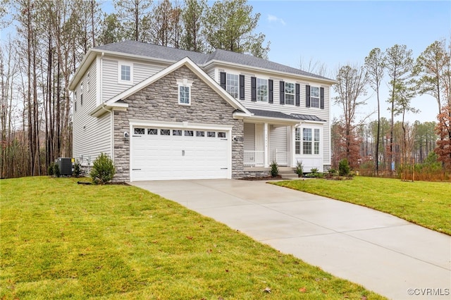 view of front of house with central air condition unit, a front yard, and a garage