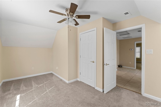 additional living space with ceiling fan, light colored carpet, and vaulted ceiling