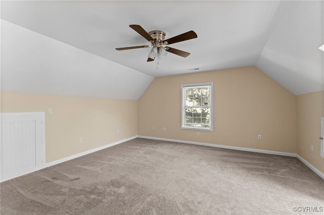 additional living space featuring carpet flooring, ceiling fan, and vaulted ceiling