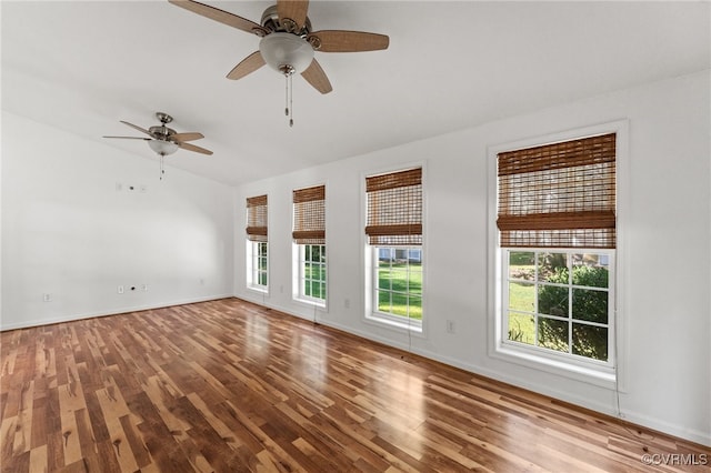 unfurnished room featuring lofted ceiling, ceiling fan, and hardwood / wood-style flooring