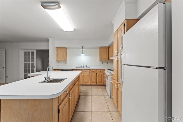 kitchen with light tile patterned floors, white appliances, an island with sink, and sink