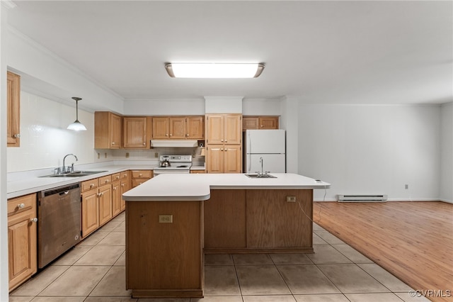 kitchen featuring decorative light fixtures, white appliances, a center island, and light hardwood / wood-style floors