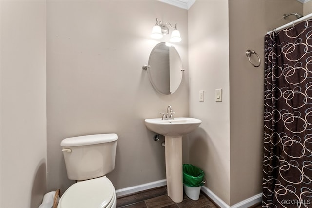 bathroom featuring walk in shower, toilet, ornamental molding, and hardwood / wood-style flooring