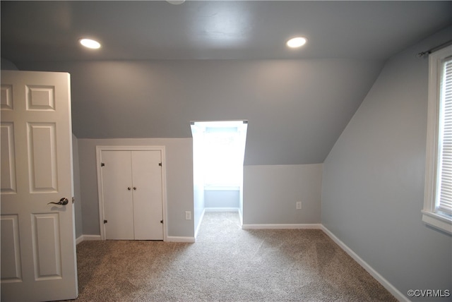 bonus room with carpet floors and lofted ceiling