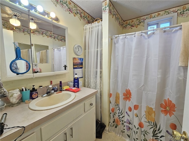 bathroom featuring vanity, a textured ceiling, and curtained shower