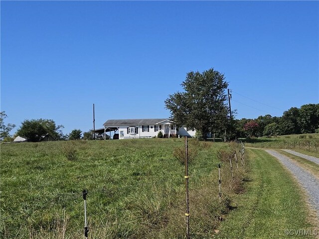 view of front facade with a rural view