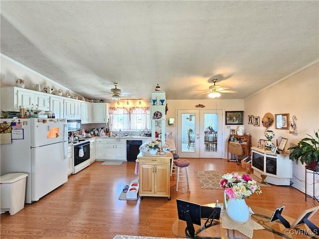 288 Cole Comfort Rd, Dillwyn, VA 23936 - kitchen featuring light wood-style flooring, a ceiling fan, a textured ceiling, range with electric stovetop, and freestanding refrigerator