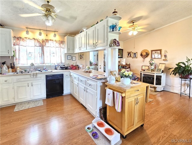 kitchen with dishwasher, light hardwood / wood-style floors, white cabinetry, ceiling fan, and a textured ceiling