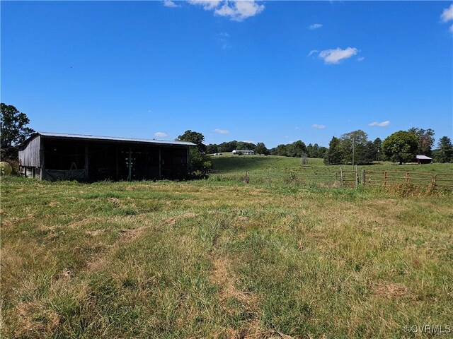 view of yard with a rural view and an outdoor structure