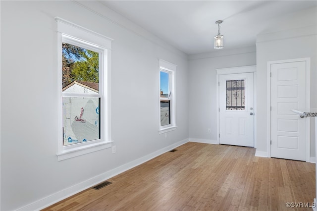 entryway featuring light hardwood / wood-style floors and ornamental molding