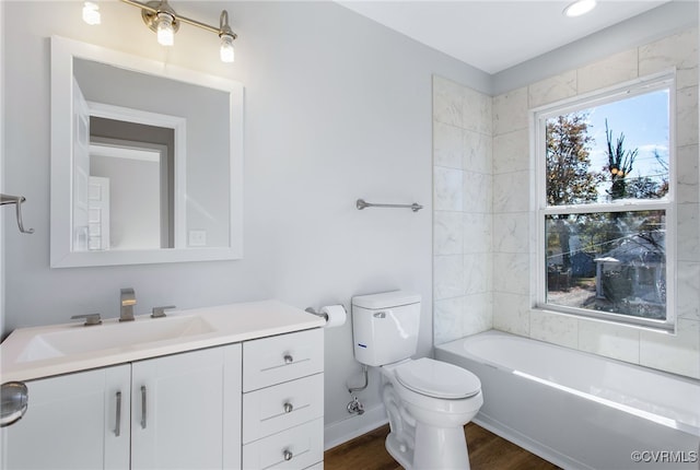 full bathroom featuring vanity, hardwood / wood-style flooring, toilet, and  shower combination