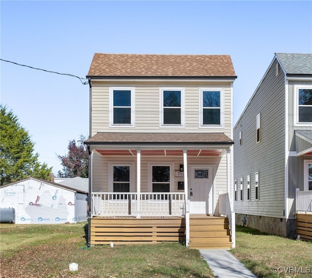 view of front of home with a porch and a front lawn