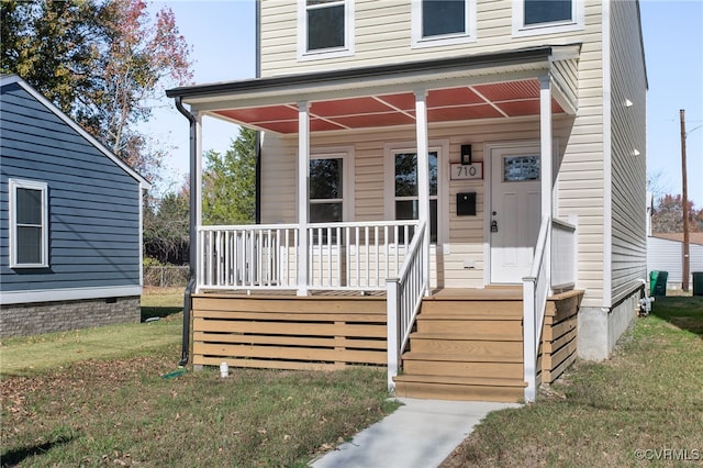 view of front of house with a front lawn and covered porch