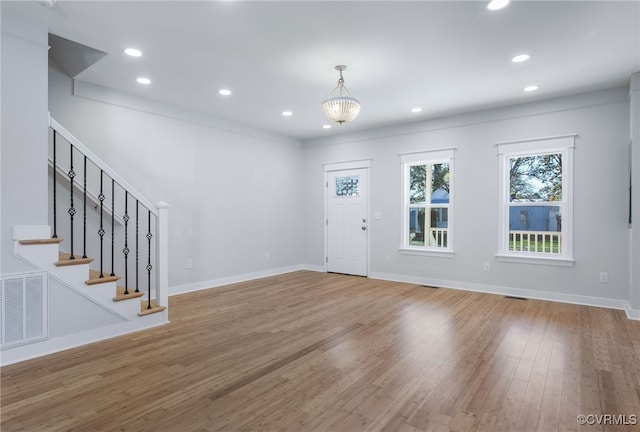 foyer entrance featuring a chandelier and hardwood / wood-style flooring