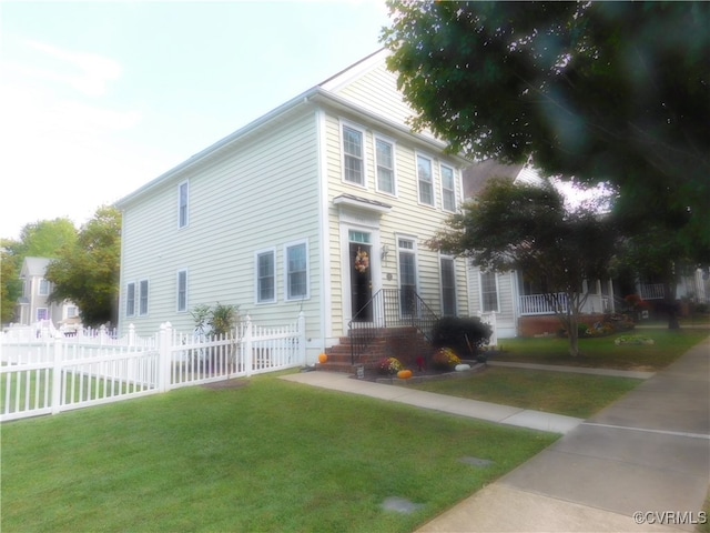 colonial-style house featuring a front lawn