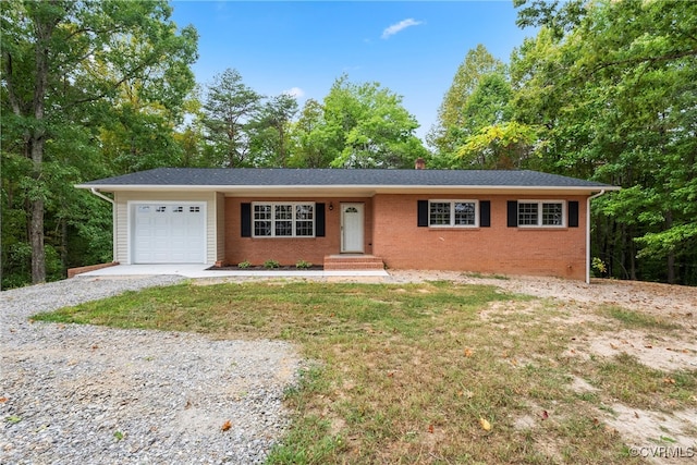 ranch-style home with a garage and a front lawn