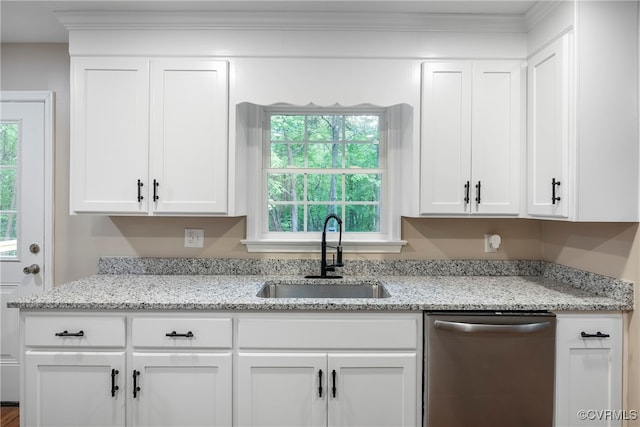 kitchen with light stone countertops, stainless steel dishwasher, white cabinetry, and sink