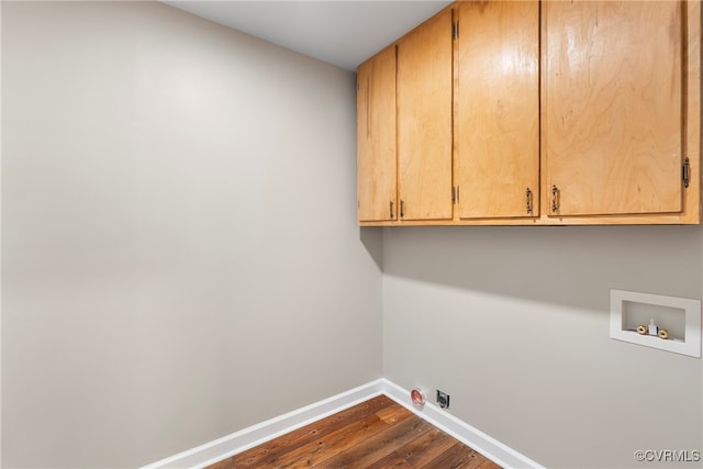 laundry area with dark hardwood / wood-style flooring, washer hookup, and cabinets