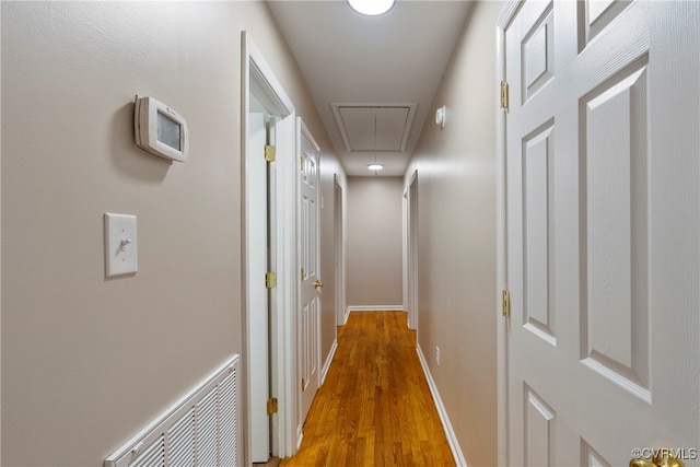 hall with hardwood / wood-style floors