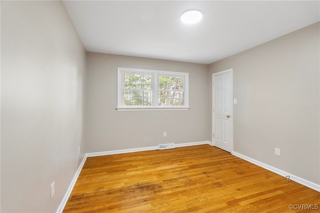 empty room with light hardwood / wood-style floors