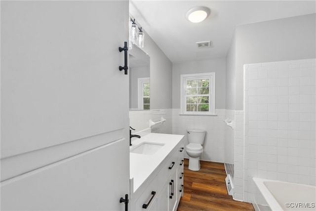 bathroom with vanity, tile walls, hardwood / wood-style floors, and toilet