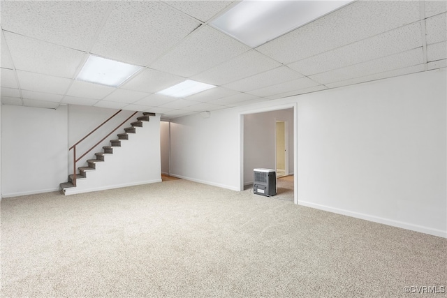 basement featuring carpet floors and a drop ceiling