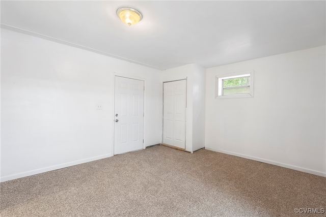 unfurnished bedroom with a closet and carpet flooring