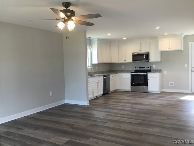 kitchen with stainless steel appliances, white cabinets, ceiling fan, and dark wood-type flooring