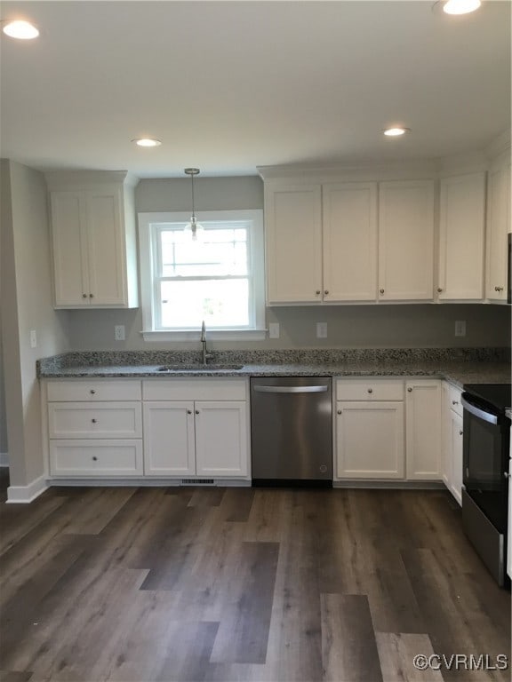 kitchen featuring white cabinetry, sink, dark wood-type flooring, and stainless steel appliances