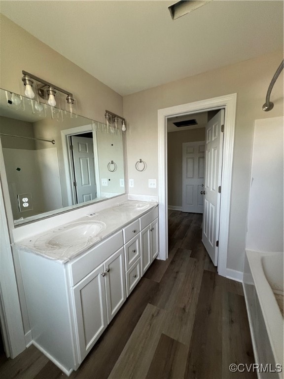 bathroom featuring shower / tub combination, wood-type flooring, and vanity