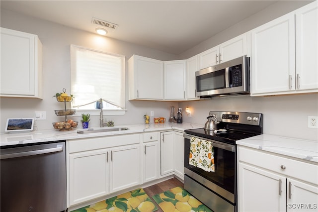 kitchen with white cabinets, sink, and stainless steel appliances