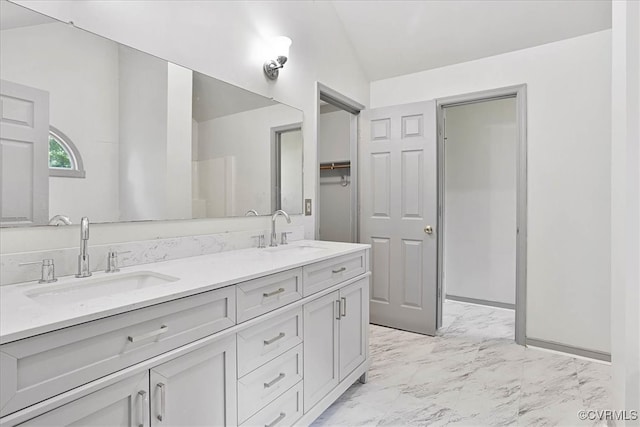 bathroom with vanity and vaulted ceiling