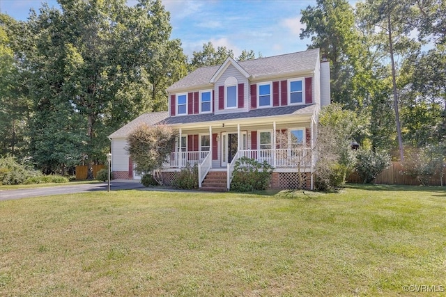 colonial inspired home with a front lawn and covered porch