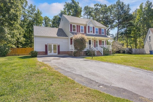 colonial-style house with a porch and a front yard