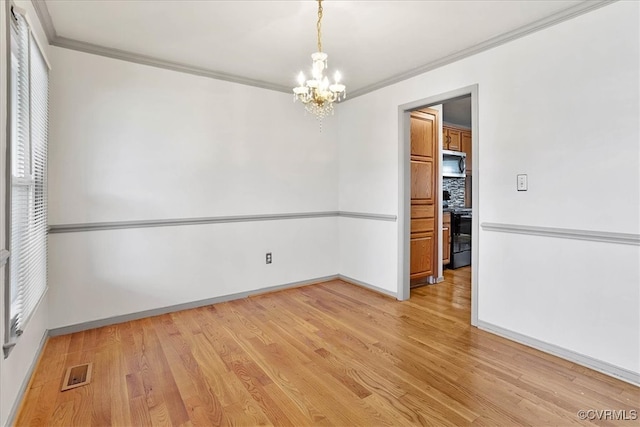 unfurnished room with a notable chandelier, light wood-type flooring, and ornamental molding