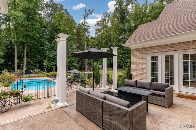 view of patio / terrace with an outdoor living space and a fenced in pool