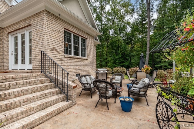 view of patio with a grill and a fire pit